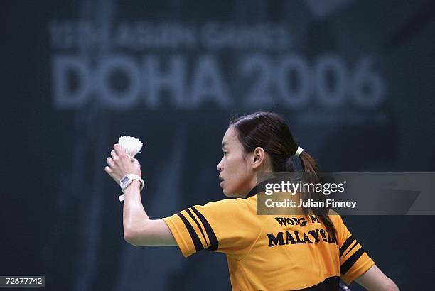 Mew Choo Wong of Malaysia serves the shuttlecock in the Women's Team Badminton match during the 15th Asian Games Doha 2006 at Aspire Hall on November...