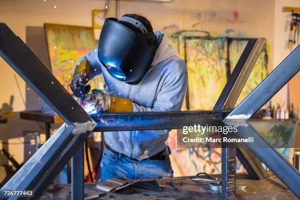 caucasian man welding metal sculpture - tig welding stock pictures, royalty-free photos & images