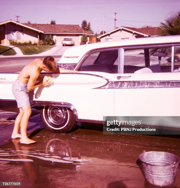 caucasian boy washing car - archival car stock pictures, royalty-free photos & images