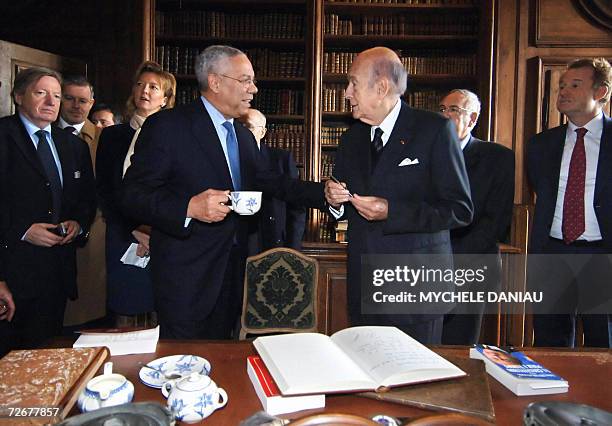 Former US Secretary of State Colin Powell talks with former French President Valery Giscard d'Estaing , after being awarded the Alexis de Tocqueville...