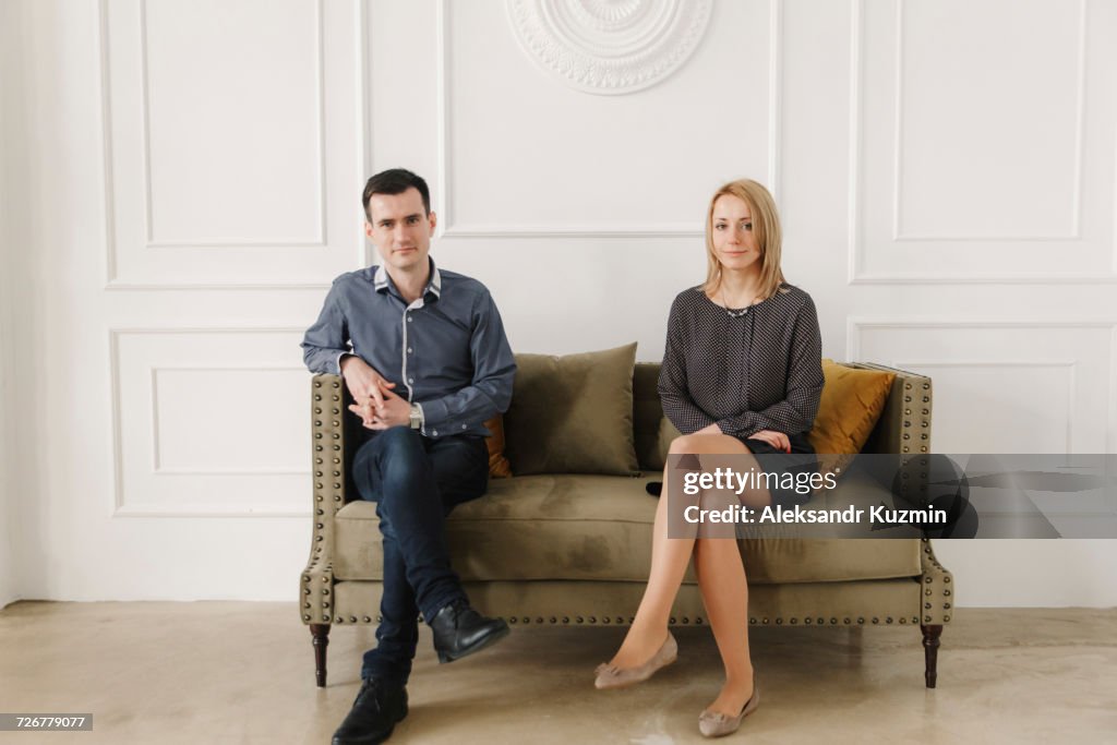 Portrait of Middle Eastern couple sitting on sofa