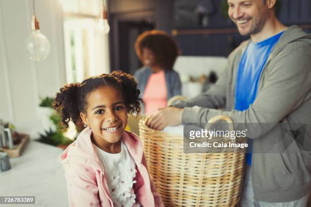 portrait smiling daughter with father in kitchen - man washing basket child stock pictures, royalty-free photos & images