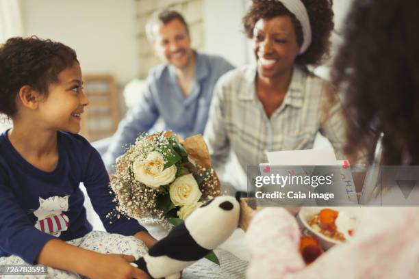 daughters serving breakfast and flowers to mother in bed on mothers day - mother's day breakfast stock pictures, royalty-free photos & images