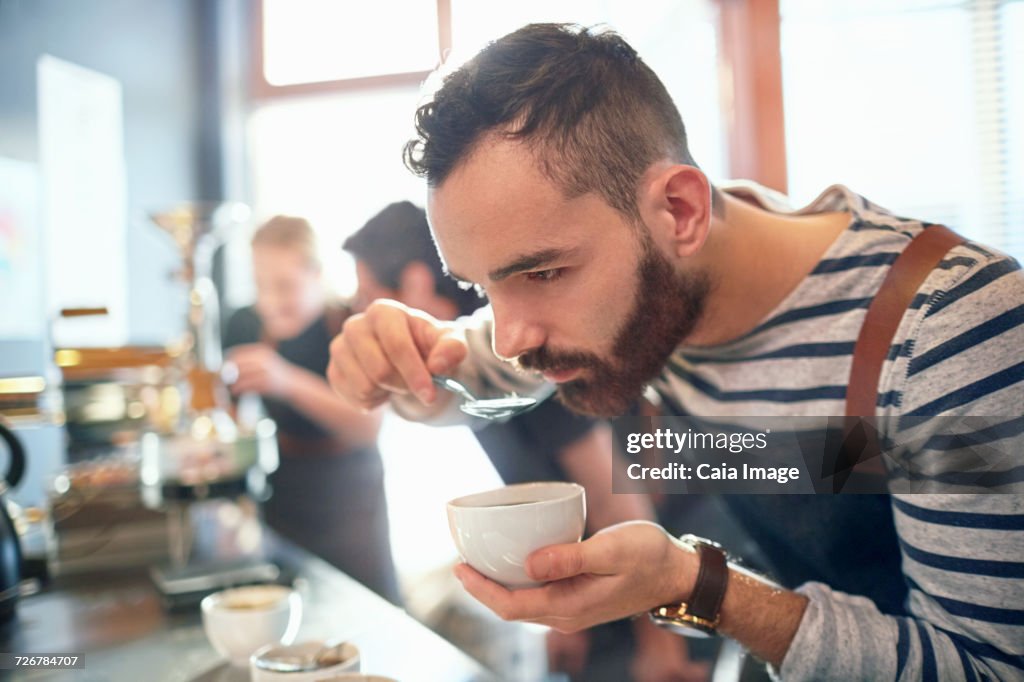 Male coffee roaster tasting coffee