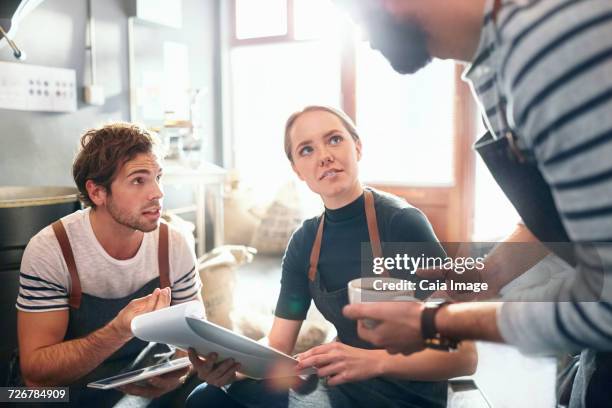 coffee roasters with clipboard talking and tasting coffee in meeting - examining food stock pictures, royalty-free photos & images