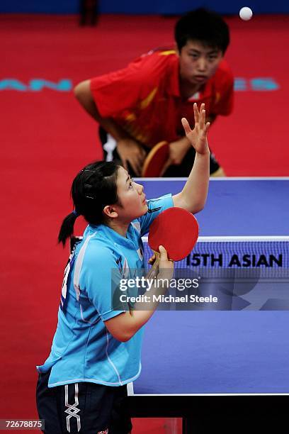 Ai Kukuhara of Japan serves to Guo Yue of China during the Women's Table Tennis Team Quarter Finals at the 15th Asian Games Doha 2006 at Al-Arabi...