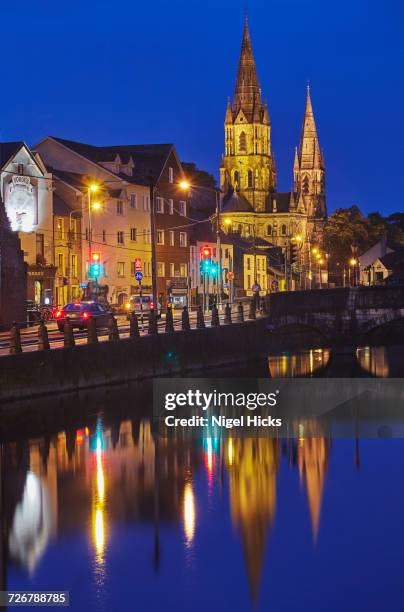 a dusk view of st. fin barres cathedral, on the banks of the lee river, in cork, county cork, munster, republic of ireland, europe - river lee cork stock pictures, royalty-free photos & images