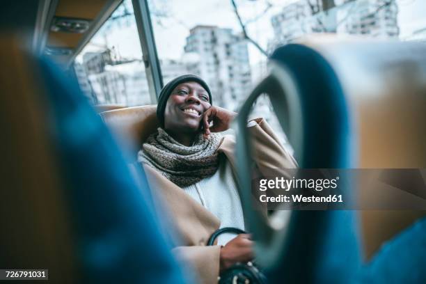 smiling young woman traveling by bus - public transportation fotografías e imágenes de stock