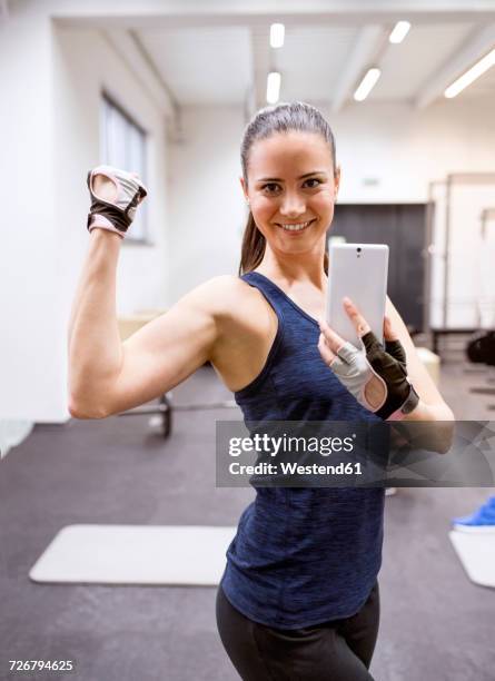 young female athete taking selfies in gym - results gym stock-fotos und bilder