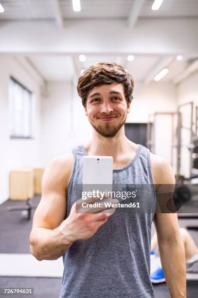 young athete taking selfies in gym - one man only studio stock pictures, royalty-free photos & images