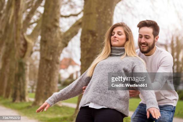 young couple outdoors - falling in love stockfoto's en -beelden