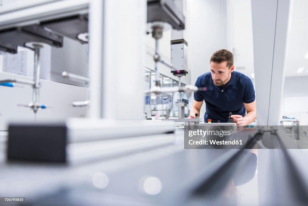 Man operating machine in testing instrument room