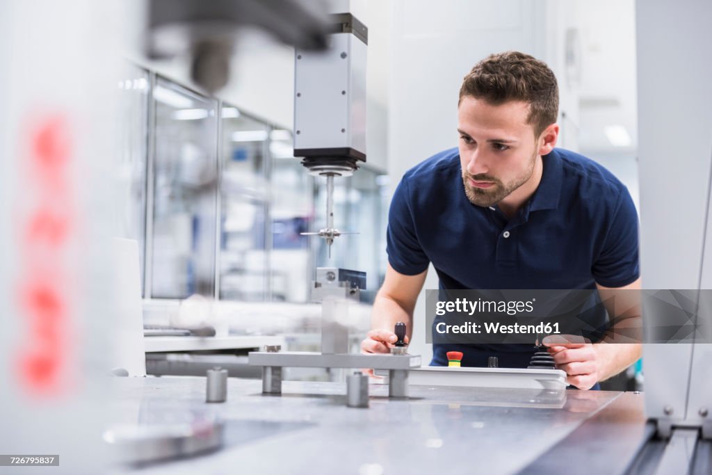 Man operating machine in testing instrument room