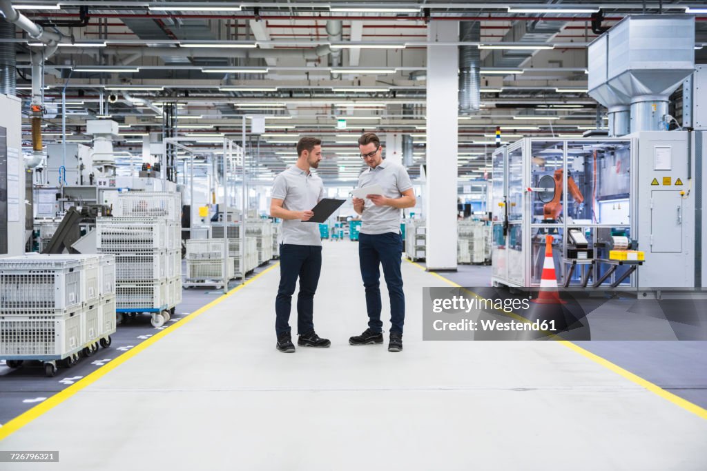 Two Men Talking In Factory Shop Floor High-Res Stock Photo - Getty Images