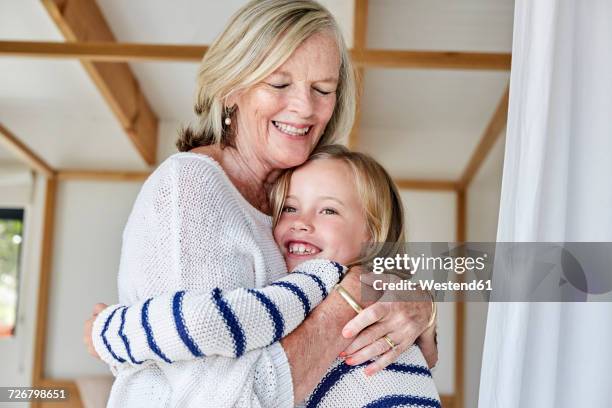 little girl hugging her grandmother - granny stockfoto's en -beelden
