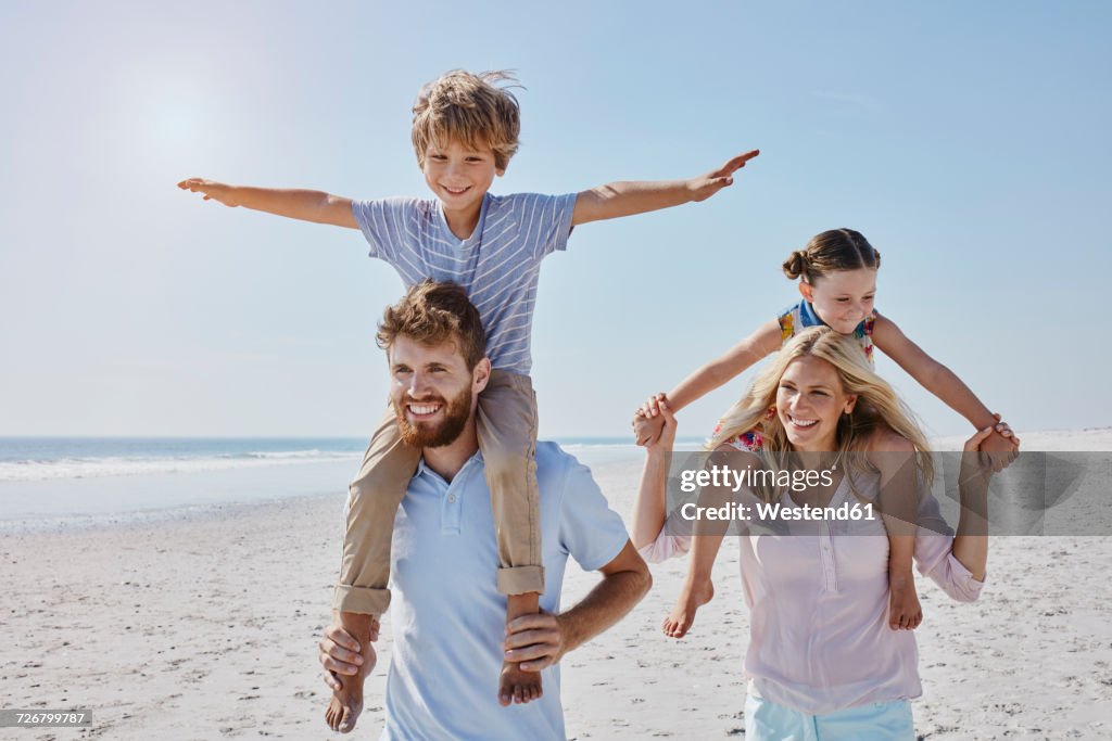 Happy family strolling on the beach