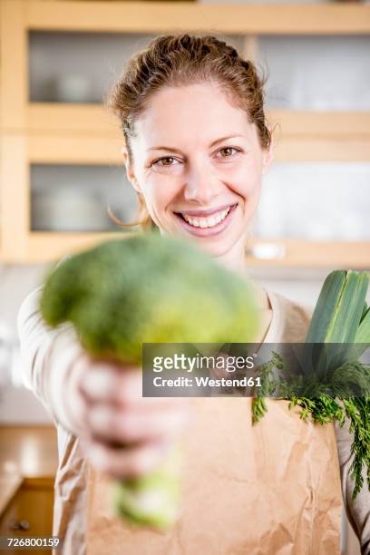 portrait of happy woman holding broccoli - cabbage stock pictures, royalty-free photos & images