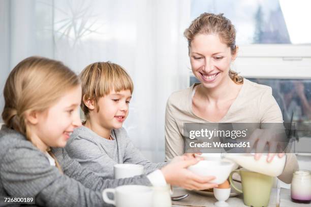 family having breakfast together - mother son milk imagens e fotografias de stock