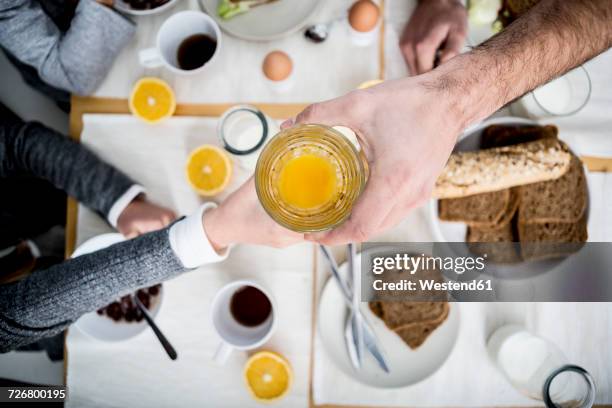 father giving child glass of orange juice - man offering bread stock pictures, royalty-free photos & images