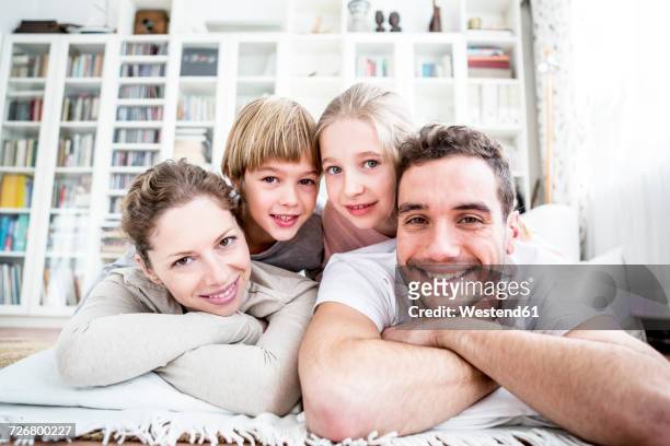 portrait of happy family at home - four people stock-fotos und bilder
