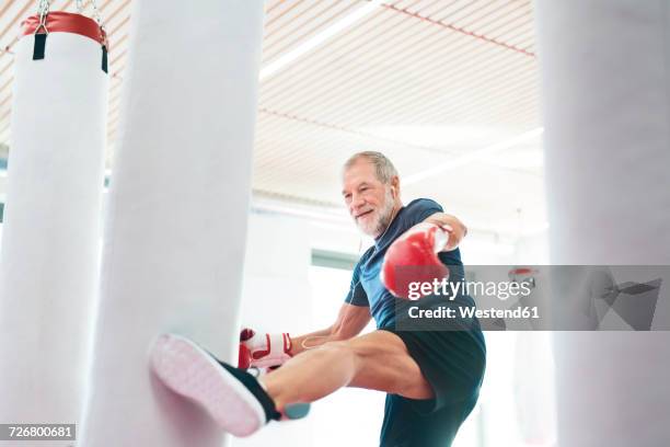 fit senior man in boxing gloves fighting - kickboxing stock pictures, royalty-free photos & images