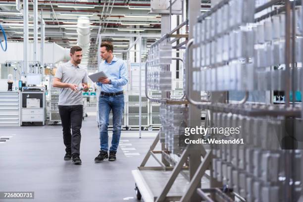 two men with tablet talking about a product in factory shop floor - 判決 ストックフォトと画像