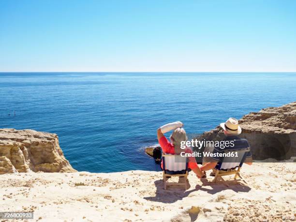 spain, andalusia, cabo de gata, back view of couple looking at the sea - retirement beach stock pictures, royalty-free photos & images