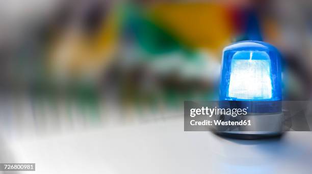 blue light on police car, close-up - cop car photos et images de collection