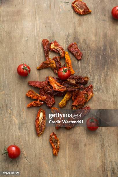 dried tomatoes and fresh tomatoes on wood - sonnengetrocknete tomate stock-fotos und bilder