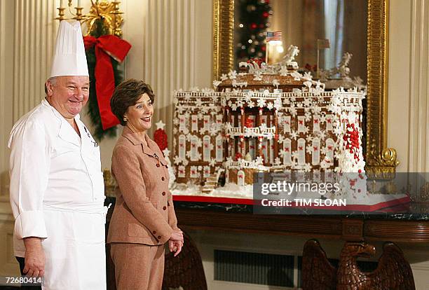 Washington, UNITED STATES: US First lady Laura Bush stands with Guest Pastry Chef Roland Mesnier while talking about the ginger bread White House he...