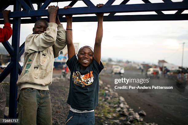 Unidentified street children play as the suns sets on October 1, 2006 in central Goma, DRC. The city has many young street children and child...