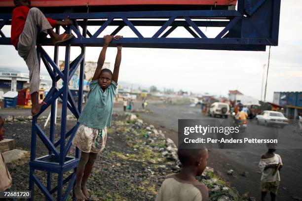 Unidentified street children play as the suns sets on October 1, 2006 in central Goma, DRC. The city has many young street children and child...