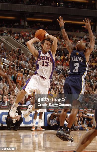 Steve Nash of the Phoenix Suns passes against Chucky Atkins the Memphis Grizzlies at US Airways Center on November 11, 2006 in Phoenix, Arizona. The...
