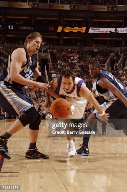 Steve Nash of the Phoenix Suns goes after a loose ball between Mike Miller and Eddie Jones of the Memphis Grizzlies at US Airways Center on November...