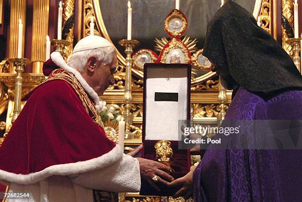 Pope Benedict XVI exchanges gifts with the Armenian Patriarch at the St. Gregor church on November 30, 2006 in Istanbul, Turkey. The Pope visited...