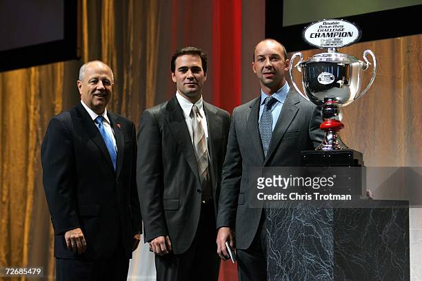 The 2006 NASCAR Nextel Cup Series Champion Jimmie Johnson, and the 2006 NASCAR Nextel Cup Series Champion crew chief Chad Knaus, receive the Checkers...