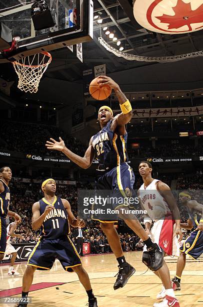 Al Harrington of the Indiana Pacers rebounds against the Toronto Raptors on November 26, 2006 at the Air Canada Centre in Toronto, Canada. The...