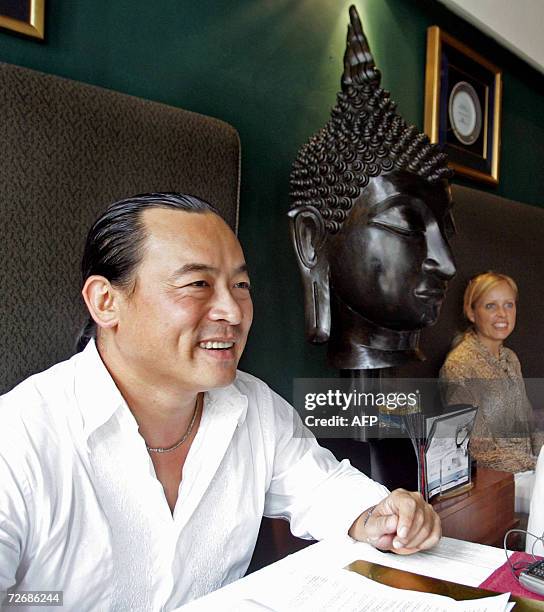 AFPLifestyle-Singapore-food-business-Laos Former Laotian refugee Michael Ma looks and his girlfriend Camilla sit at his first IndoChine outlet in...