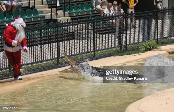 Santa Claus is chased by a crocodile as Robert Irwin and mum Terri Irwin celebrate Bob's third birthday at Australia Zoo, Beerwah on December 1, 2006...