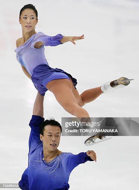 Chinese skater Zhao Hongbo lifts his parter Shen Xue during their free skating of pair event in the NHK Trophy Figure Skating competition in Nagano,...