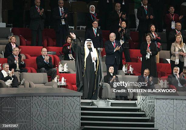 His Highness Sheikh Hamad Bin Khalifa al-Thani, the Emir of Qatar, waves from the VIP podium at the 15th Asian Games, next to International Olympic...