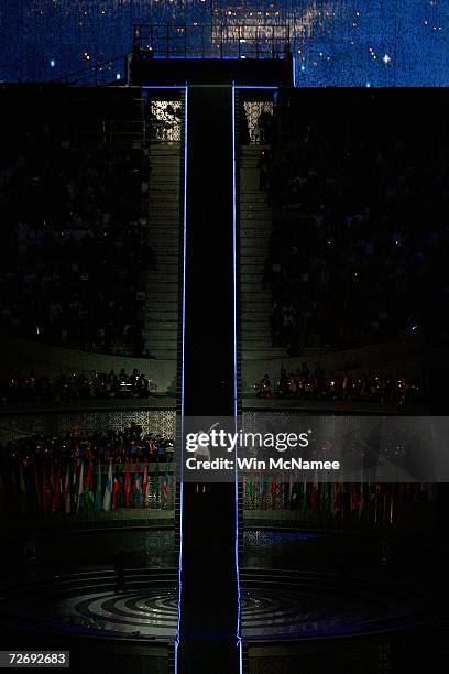 The torchbear makes his way to light the flame inside the stadium during the Opening Ceremony of the 15th Asian Games Doha 2006 at the Khalifa...