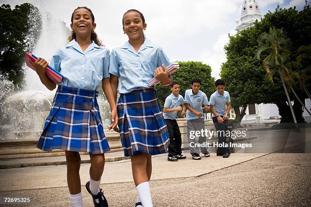 school children socializing in center plaza - girls in plaid skirts stock pictures, royalty-free photos & images