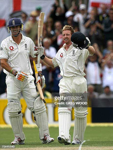 England batsman Paul Collingwood with teammate Kevin Pietersen raises his arms after scoring a century on day two of the second Ashes cricket Test...