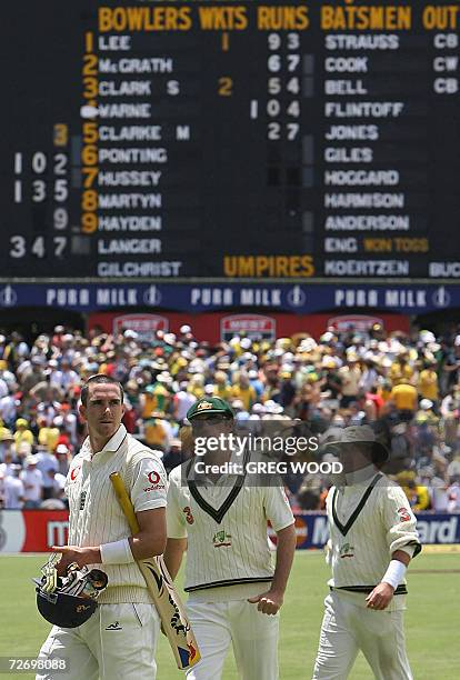 England batsmen Paul Collingwood and Kevin Pietersen lead off Australia's Glenn McGrath and Shane Warne in front of the scoreboard at lunch on day...