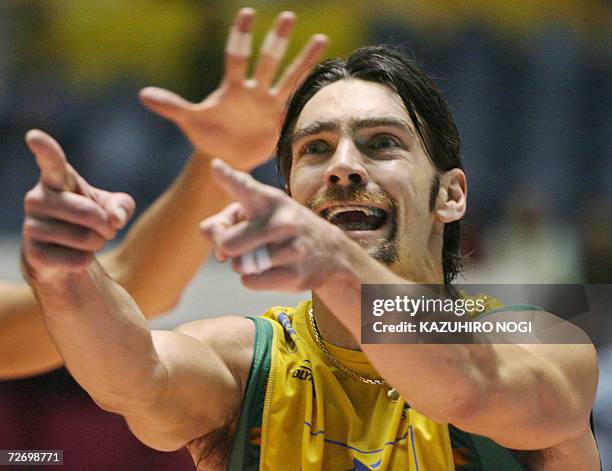 Brazilian ace player Gilberto 'Giba' Godoy Filho points to his teammate as he celebrates a point against Serbia Montenegro during their semi-final...