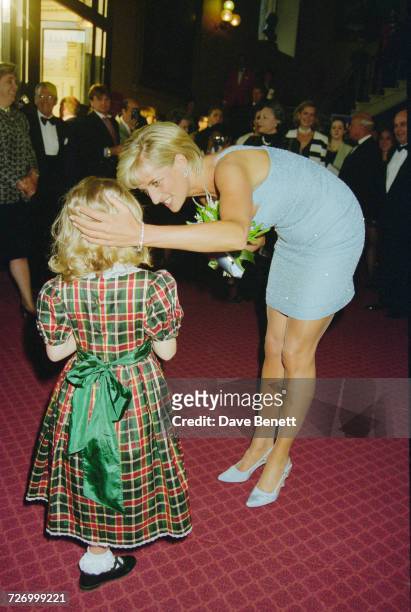 Princess Diana receives a bouquet from a young girl at the Royal Albert Hall after an English National Ballet production of 'Swan Lake', London, 3rd...