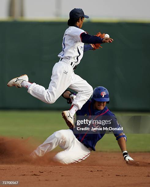 Anukul Sudsawad of Thailand tags Lin Chih Sheng of Chinese Taipei at second base during the Men's Single Round Robin Game 5 during Day 2 of the 15th...