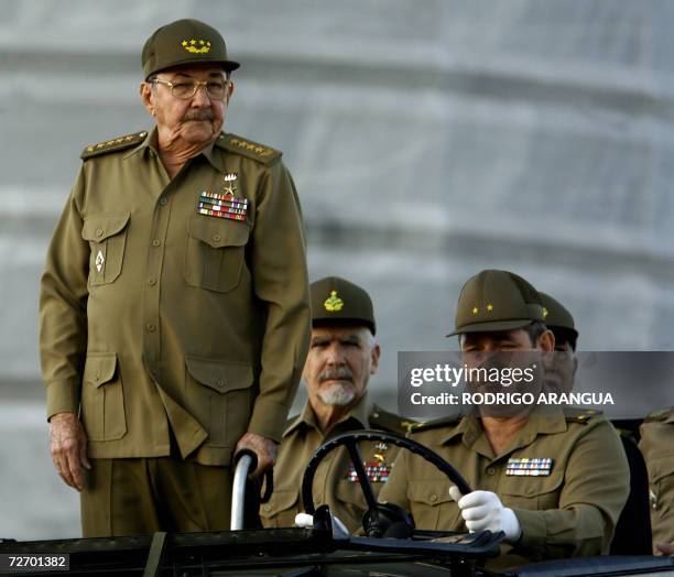 Cuban acting President and chief of Cuban Army Raul Castro stands next to revolution commander Ramiro Valdez during a military parade celebrating...