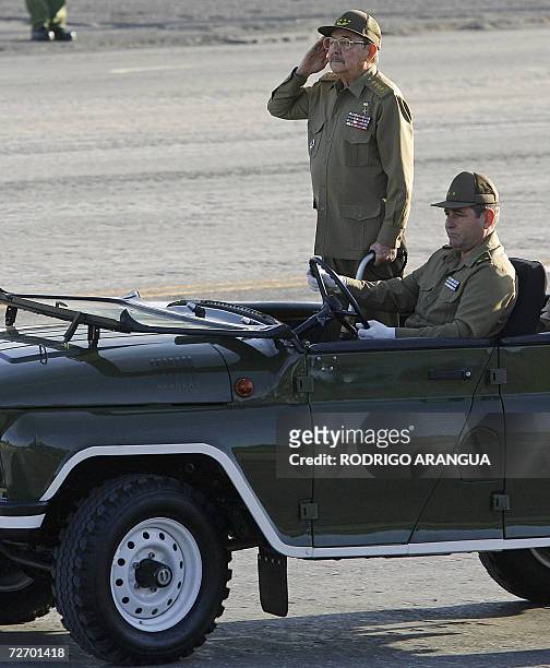 Cuban acting President and chief of the Cuban Army Raul Castro salutes during a military parade 02 December 2006 at the Revolution Square in Havana,...